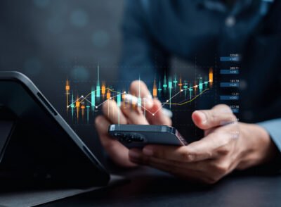 Businessmen investor think before buying stock market investment using smartphone to analyze trading data. investor analysis with stock exchange graph on screen. Financial stock market.